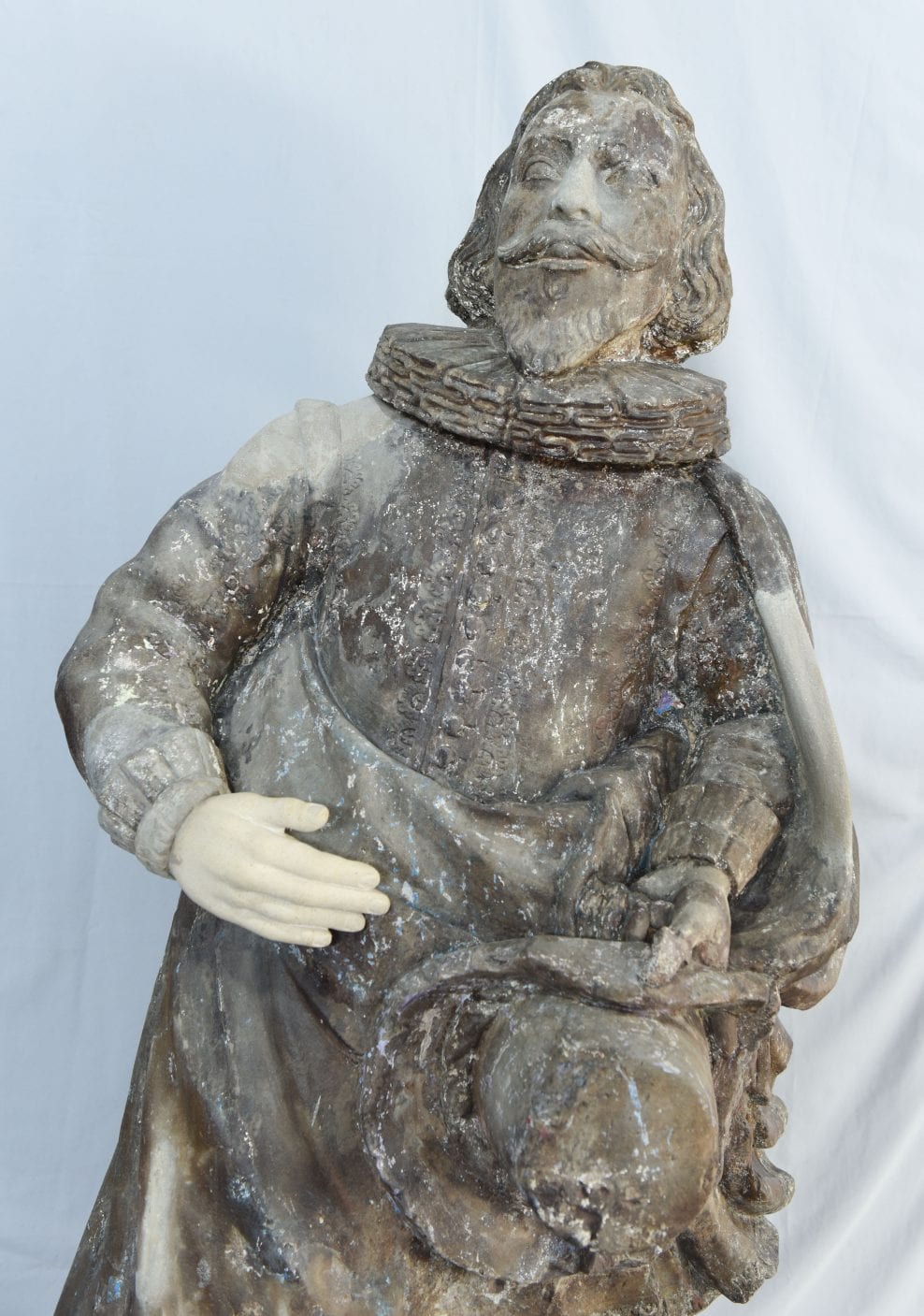 During replacing of missing stone hand, nose and cloak details following research