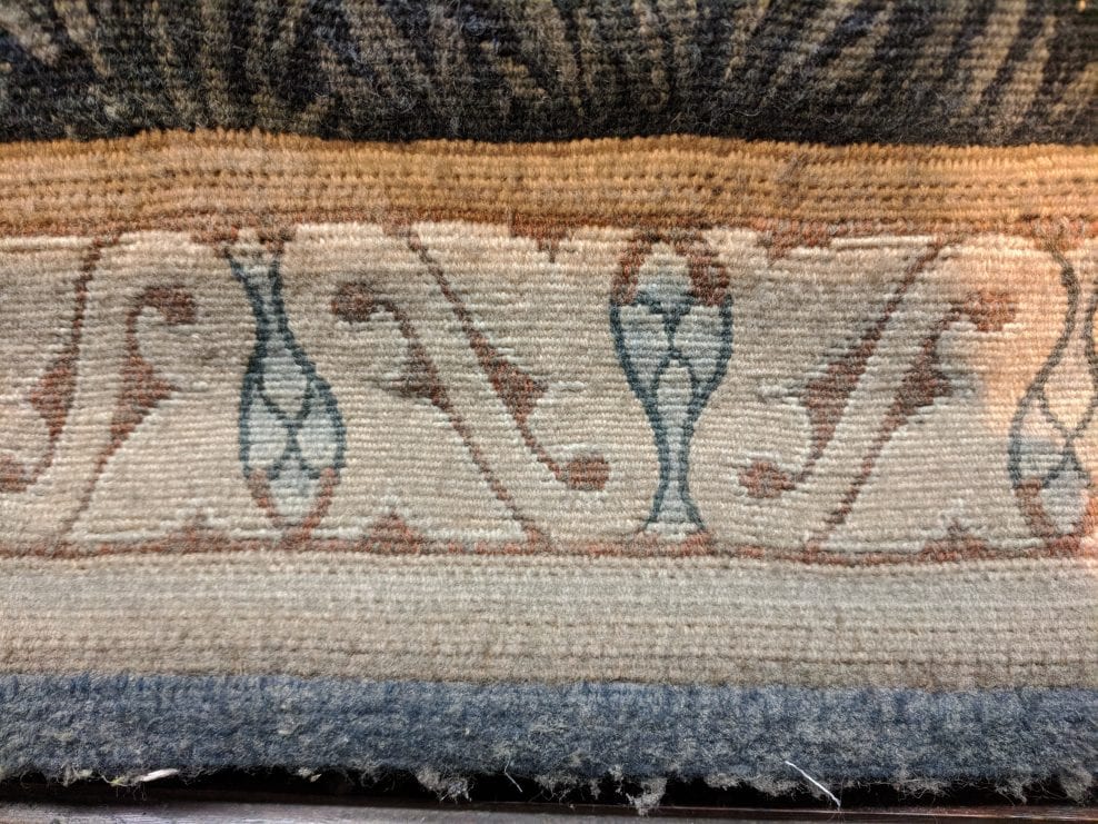Showing the amount and thickness of the dust and dirt on the tapestry, especially on the bottom