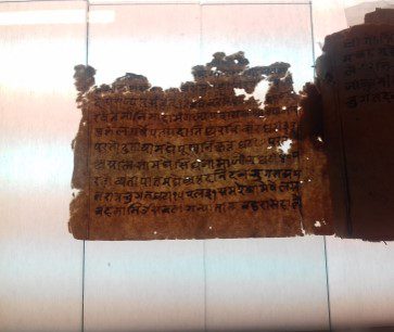 Hindi manuscript with mould, insect damage and adhered pages.