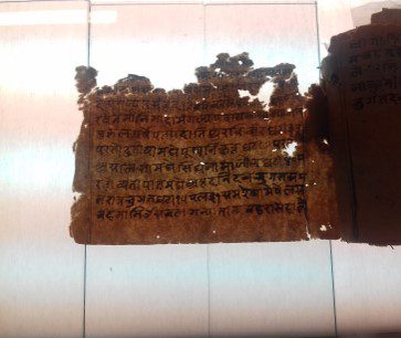 Historical manuscript with mould, insect damage and adhered pages.