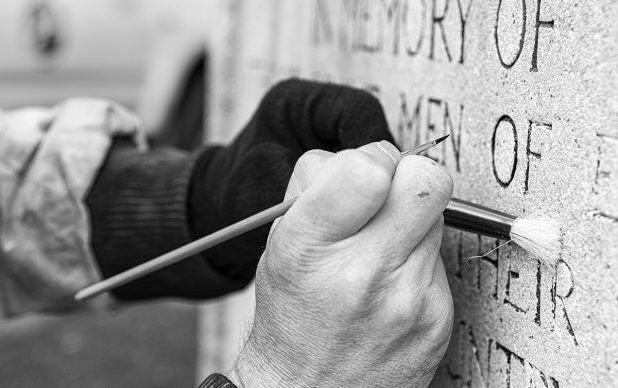 Re-touching lettering to the Memorial.