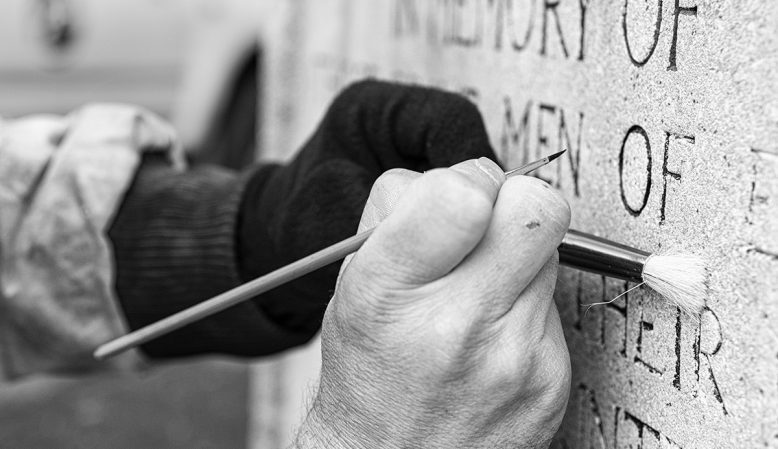 Re-touching lettering to the Memorial.